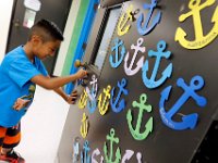 1009397793 ma nb HayMacFistDay  Danilo Ixcuna places an anchor with his name on the door to his class on the first day of school at the Hayden McFadden Elementary School in New Bedford.  PETER PEREIRA/THE STANDARD-TIMES/SCMG : education, school, students